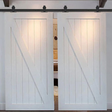 Pair of white sliding barn doors with a track system on a white wall.