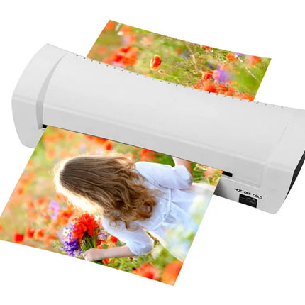 A white portable photo printer shown printing two colorful flower-field photographs on a plain white background.