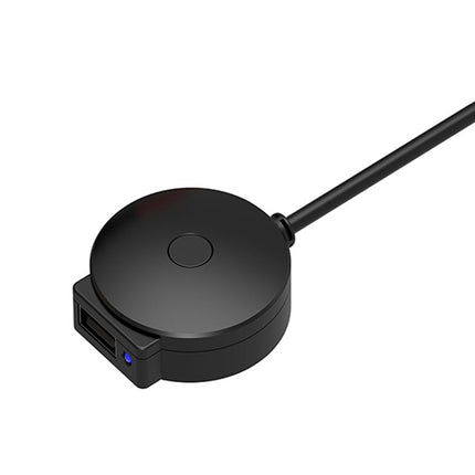 Black circular device with a cable on a white background
