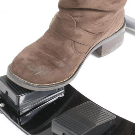 Brown boot stepping on a metal foot pedal with a white background