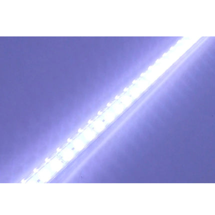 Strip of LED lights on a reflective surface with a white background