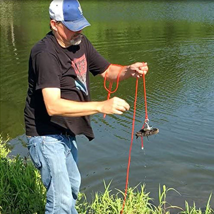 Man fishing by a lake with a red fishing rod and a fish on the hook.