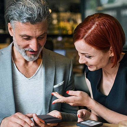Man and woman looking at a phone together in a casual setting