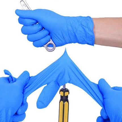 Hands wearing blue gloves holding various small tools on a white background