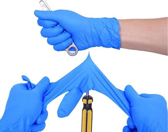 Hands wearing blue gloves holding various small tools on a white background