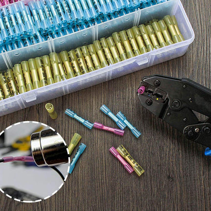 A plastic storage organizer filled with colorful wire connectors, alongside a black and blue crimping tool, loose connector pieces, and a circular inset showing a close-up of a connector being crimped, all on a dark wood surface.