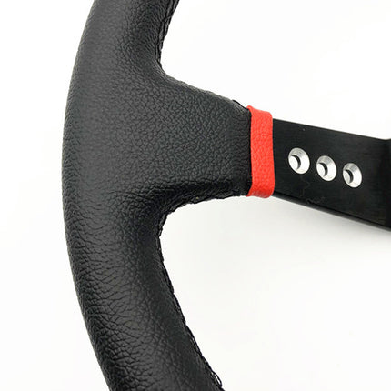 Close-up of a black textured steering wheel with a bright red accent ring and a black metal center column on a white background.