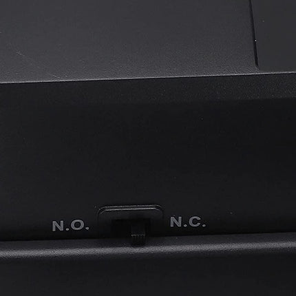 Close-up of a black electronic device with 'N.O.' and 'N.C.' labels.