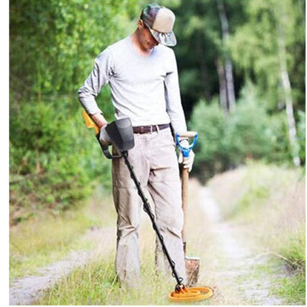 Person using a grass trimmer in a forested area
