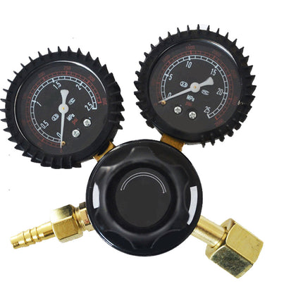 Three-section pressure gauge with black and gold components on a white background