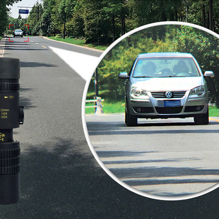 Black telescope on a road with a close-up of a car in the background