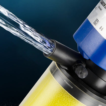 Water filter with water flowing out against a dark background