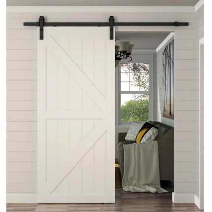 Barn door with black hardware in a home interior setting