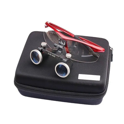 Red-framed magnifying glasses with clear lenses resting on a black zippered carrying case against a white background.