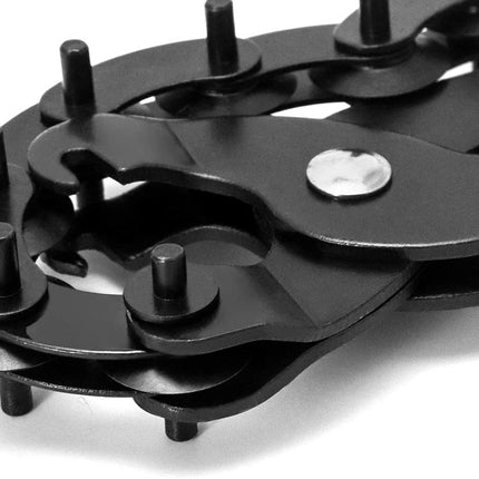 Close-up of a black metal chain with a white background