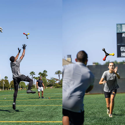 People playing with a colorful ball on a sports field with a scoreboard in the background.