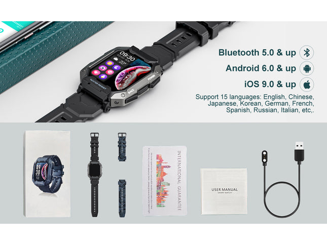 Smartwatch with accessories on a gray surface, including a cable and user manual.