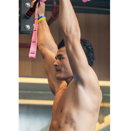 Man exercising with resistance bands in a gym setting