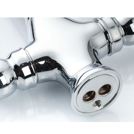 Chrome faucet handle on a white background