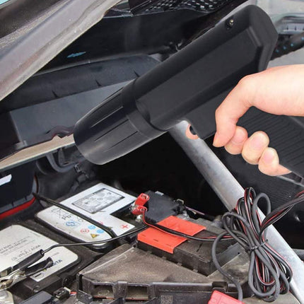 Person working on a car battery with a tool