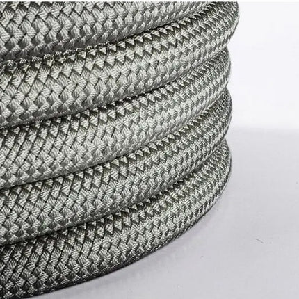 A close-up of a coiled gray braided rope or cable with a textured, woven surface on a plain light background.