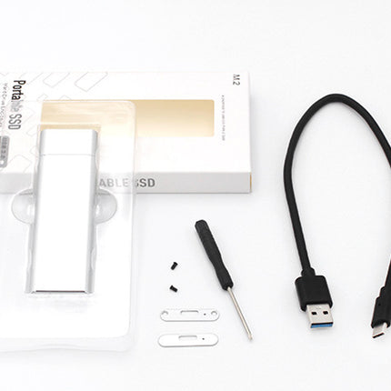 Portable SSD with packaging, screwdriver, and USB cable on a white background