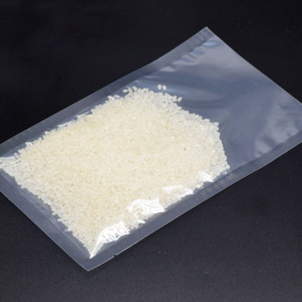 Clear plastic bag with white granular substance on a black background