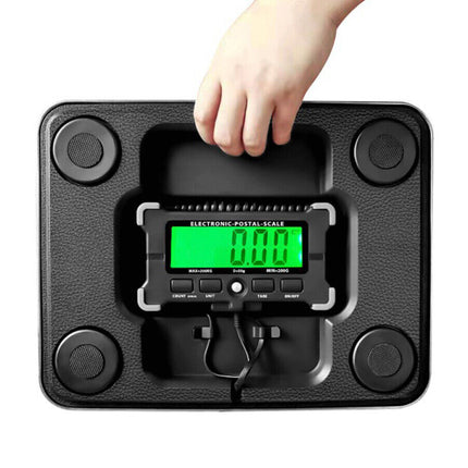 Digital postal scale with a hand pressing a button on a white background