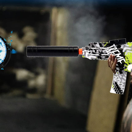 Toy gun with colorful design held by a person, with a blurred background