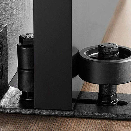 Close-up of a black metal bracket on a wooden surface