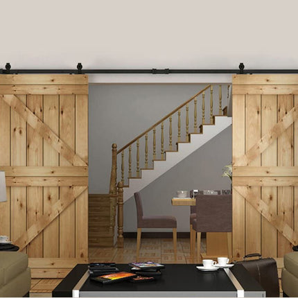 Wooden sliding barn doors in a home interior with a staircase and dining area.