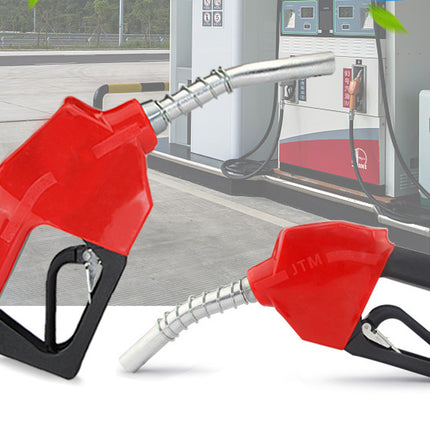 Two red fuel nozzles with black handles on a white background, with a blurred gas station in the background.