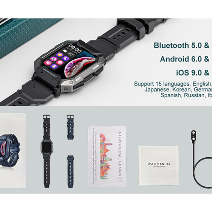 Smartwatch with accessories on a gray surface, including a cable and user manual.