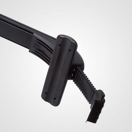 Close-up of a black plastic handlebar clamp or mounting bracket with a ribbed grip and latch, shown against a plain light gray background.