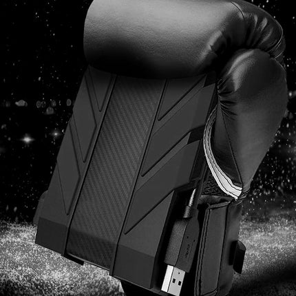 Black boxing glove with USB cable against a starry night sky background