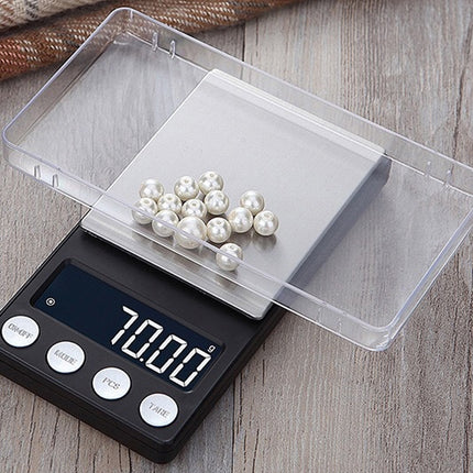 Digital scale with pearls on a wooden surface