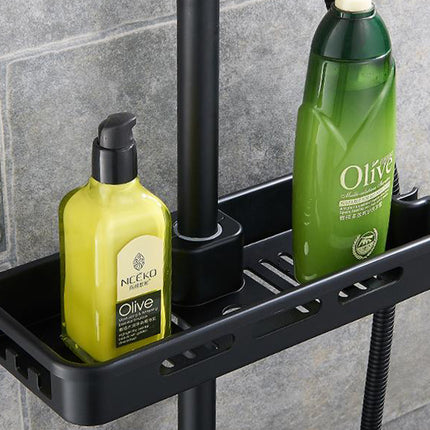 Black shower caddy with olive-themed bottles on a tiled bathroom wall.