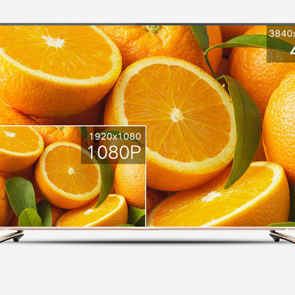 A modern flat-screen TV shown front-on against a light gray background. The screen displays a close-up orange fruit image with text overlays indicating 3840x2160, 4K, 1920x1080, and 1080P.