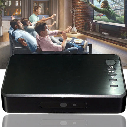 A black rectangular electronic device with a glossy top surface and front control buttons, shown prominently over a lifestyle scene of people watching TV in a living room.
