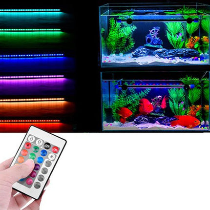 LED light strips with a remote control next to an aquarium with colorful fish.