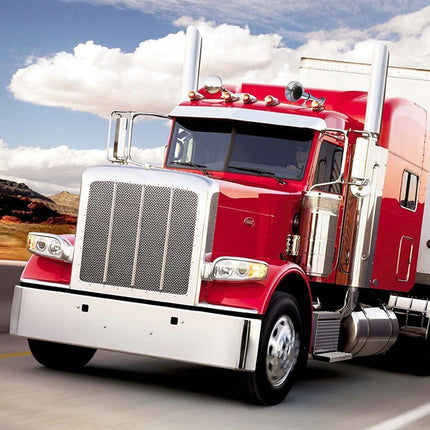A red and white semi-truck cab with chrome details driving on a highway under a blue sky with clouds.
