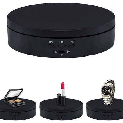 Black round electronic device with buttons, accompanied by a compact, lipstick, and watch on a white background.
