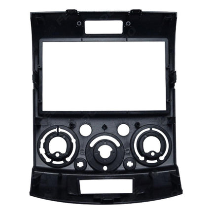 Black car dashboard panel with various holes and slots on a white background