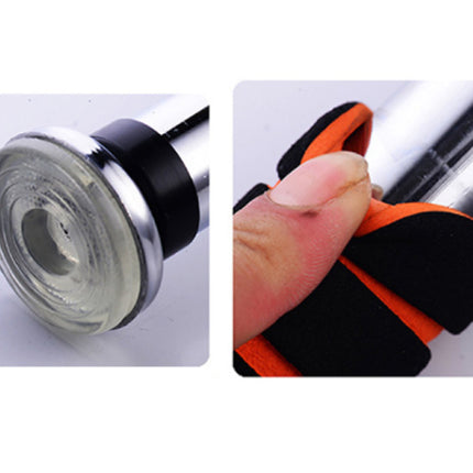Close-up of a stethoscope with a focus on the diaphragm and a hand wearing an orange and black glove.
