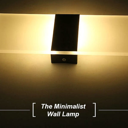 Minimalist wall lamp with a warm glow on a dark background