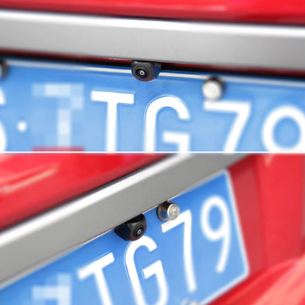 Close-up of a small black license plate camera mounted above a blue vehicle license plate on a red car frame.