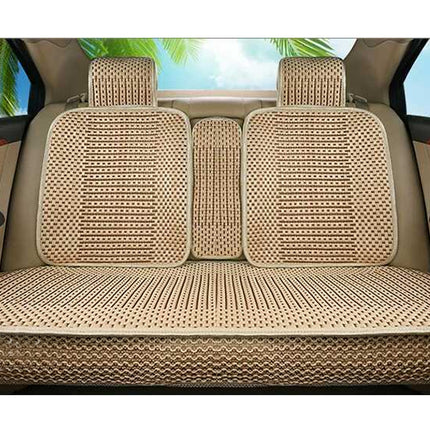 A set of beige and brown woven car seat covers installed on the back of a vehicle, including the three rear seat back cushions and the center console floor cushion.