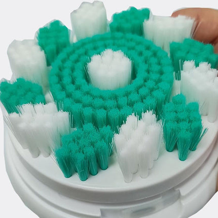 Cleaning brush head with green and white bristles on a white background