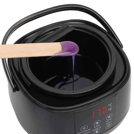 Black wax warmer with a digital display and a wooden stick with purple wax.
