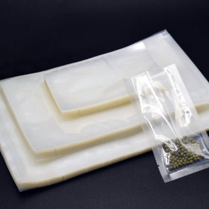 Set of plastic tools and a small bag on a white plate against a black background